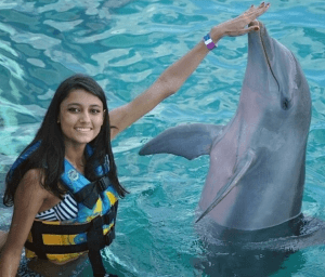 Young Lady Touches Dolphins Nose Mexico