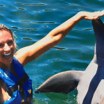 Happy Lady Touches Dolphin Mexico