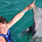Teenager touches Dolphin Mexico