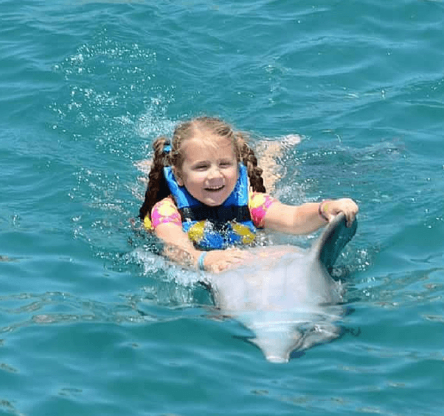 Happy Young Girl Belly Ride Dolphin Mexico